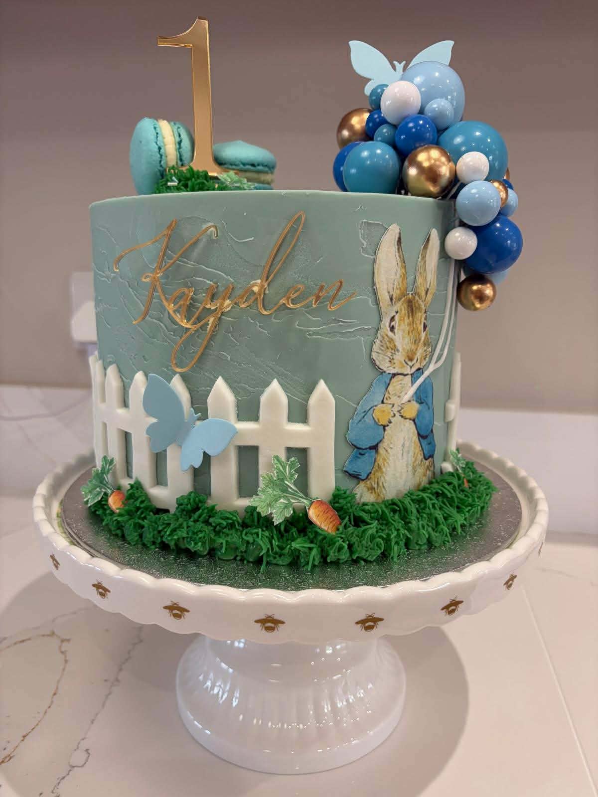 Peter Rabbit first birthday cake for Kayden, with balloons and macarons